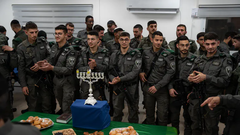 Haredi Border Police officers light the menorah